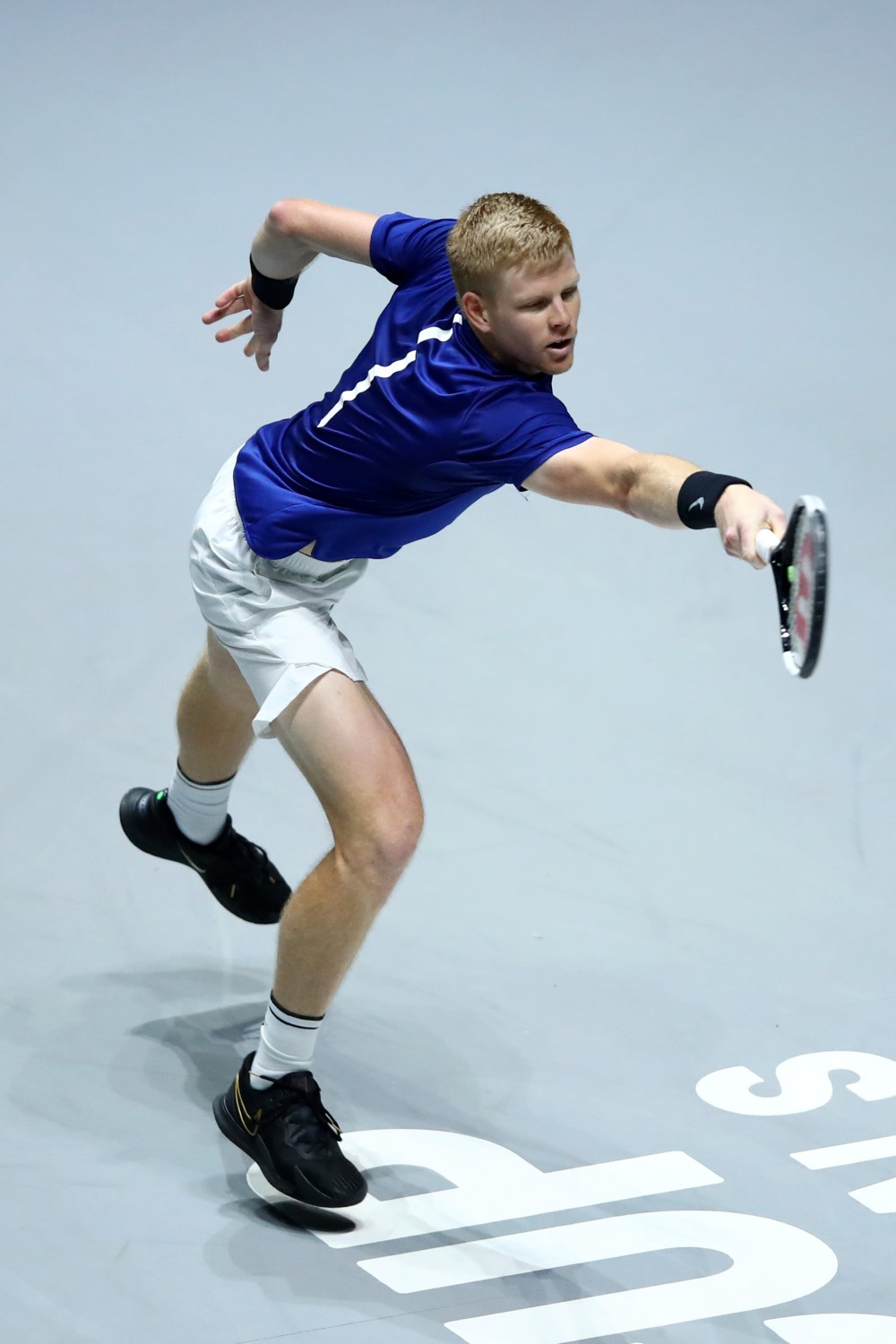 Kyle Edmund on court reaching out to hit a tennis ball with his racket