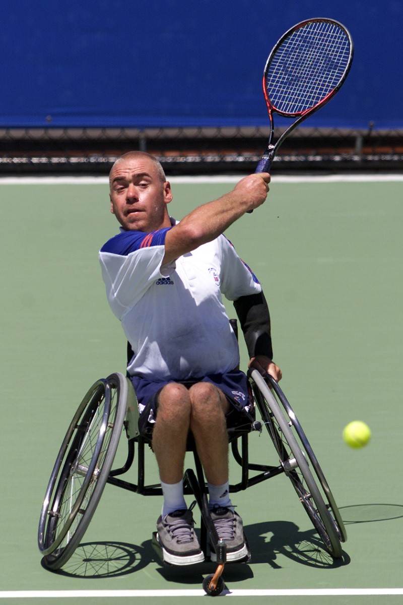 Simon Hatt on court playing wheelchair tennis