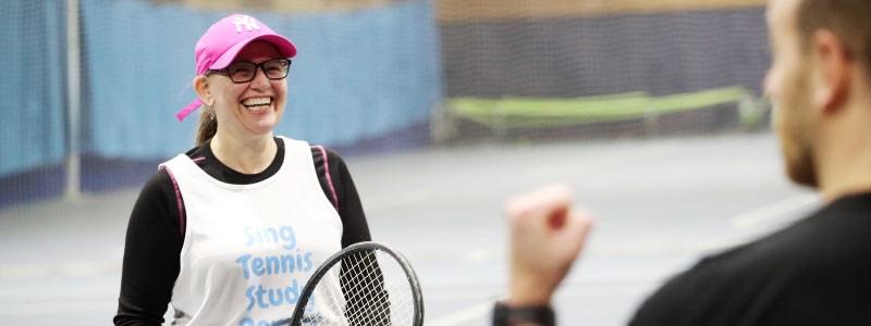 A woman on court taking part in a tennis-based fitness session.