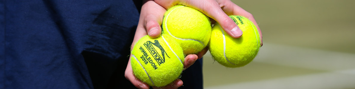 Tennis balls in the hands of ball crew