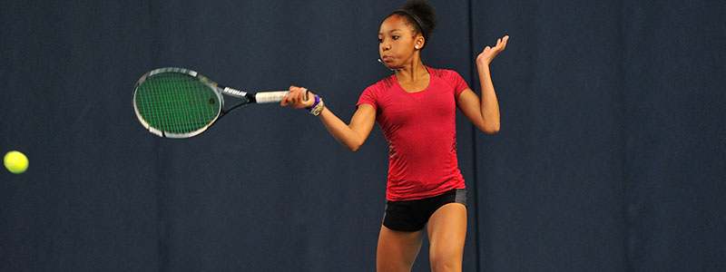 Girl hitting a tennis forehand